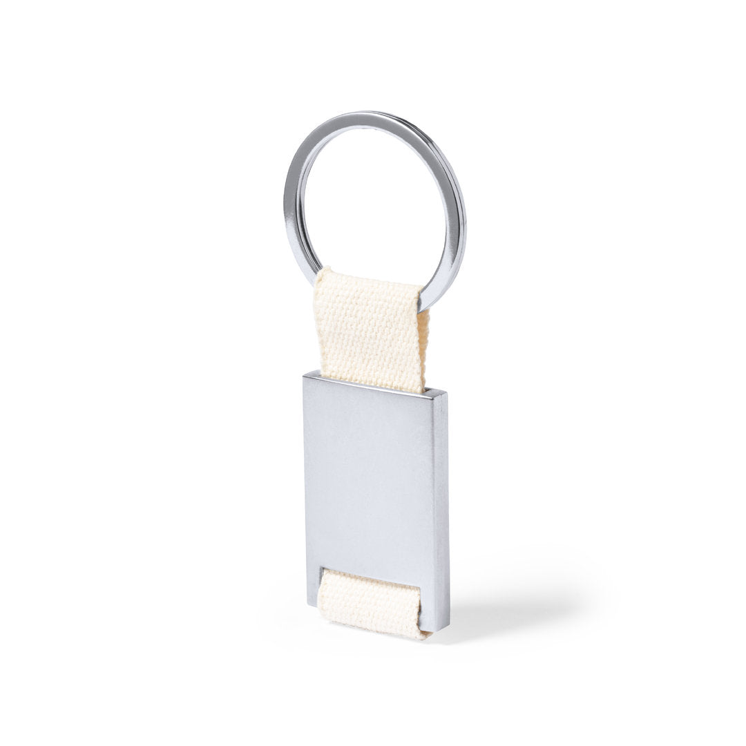 Accessoire porte-clés avec corps en métal argenté et ruban 100% coton naturel. Personnalisable - Présenté dans un sachet individuel avec carton intérieur.